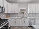 Charming kitchen with white cabinets, stainless steel appliances, and modern countertops at 1305 Bontrager Ln, Shelbyville, IN 46176