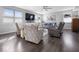 Spacious living room with a ceiling fan, fireplace, large windows and dark wood floors at 1305 Bontrager Ln, Shelbyville, IN 46176