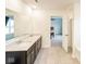 Modern bathroom featuring a double vanity with stone countertops, sleek dark cabinetry, and tile flooring at 1573 Vera Blvd, Danville, IN 46122