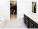 Modern bathroom with dual sinks, black cabinets, and walk in closet at 1573 Vera Blvd, Danville, IN 46122