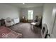 Bright bedroom with large window, plush carpet, and a Bedroom at 1573 Vera Blvd, Danville, IN 46122