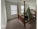 Bedroom with four-poster bed and ample natural light from the two windows at 1573 Vera Blvd, Danville, IN 46122