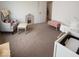 Bright bedroom with soft carpet, neutral walls, a cozy chair, and a bassinet, creating a soothing atmosphere at 1573 Vera Blvd, Danville, IN 46122