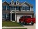Charming two-story home featuring brick and gray siding, complemented by blue shutters and a well-maintained lawn at 1573 Vera Blvd, Danville, IN 46122