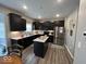 Modern kitchen with stainless steel appliances, dark cabinetry, granite countertops, and a center island at 1573 Vera Blvd, Danville, IN 46122