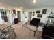 Open living room featuring neutral carpeting, decorative wall art, and comfortable seating at 1573 Vera Blvd, Danville, IN 46122