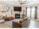 Cozy living room with fireplace, large screen TV, wood flooring and updated decor at 1573 Vera Blvd, Danville, IN 46122