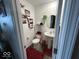 Charming powder room features a pedestal sink and decorative accents at 1573 Vera Blvd, Danville, IN 46122