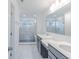 Modern bathroom with marble-tiled shower, dual vanities, and gray cabinets at 15970 Meadow Frost Ct, Fishers, IN 46037