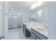 Bathroom featuring marble shower, gray cabinets, dual vanity, and modern fixtures at 15970 Meadow Frost Ct, Fishers, IN 46037