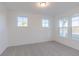 Bright bedroom with neutral carpet and three windows showcasing natural light at 15970 Meadow Frost Ct, Fishers, IN 46037
