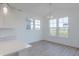 Bright dining area features hardwood floors, abundant natural light, and a modern chandelier at 15970 Meadow Frost Ct, Fishers, IN 46037