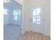 Bright foyer features wood flooring and a clear view to the carpeted flex room at 15970 Meadow Frost Ct, Fishers, IN 46037