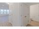 Hallway with two doors and wood flooring looks into the bathroom and a bedroom at 15970 Meadow Frost Ct, Fishers, IN 46037