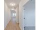 Hallway with hardwood flooring and white walls, leading to bedrooms at 15970 Meadow Frost Ct, Fishers, IN 46037