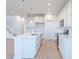 Beautiful kitchen with an island, white cabinetry, stainless steel appliances, and modern pendant lights at 15970 Meadow Frost Ct, Fishers, IN 46037