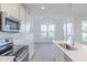 Bright kitchen featuring stainless steel appliances, a center island and a view of the dining area at 15970 Meadow Frost Ct, Fishers, IN 46037