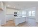 Bright kitchen with a center island, white cabinets, and stainless steel appliances under pendant lights at 15970 Meadow Frost Ct, Fishers, IN 46037