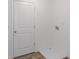 Laundry room with hardwood floors, washer hookups, and a white door at 15970 Meadow Frost Ct, Fishers, IN 46037