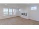 Bright living room with a modern fireplace and large windows offering scenic views at 15970 Meadow Frost Ct, Fishers, IN 46037