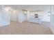 Spacious living area with a view of the kitchen, featuring white cabinets and a center island at 15970 Meadow Frost Ct, Fishers, IN 46037