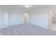 Bright carpeted bedroom with ensuite bathroom, open doorway, and ample natural light at 15970 Meadow Frost Ct, Fishers, IN 46037