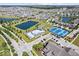 Stunning aerial view showcases a community with pools, tennis courts, a playground and lush green spaces at 1614 Waterleaf Dr, Westfield, IN 46074