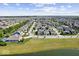 Scenic aerial view of a neighborhood showing houses with well-manicured lawns and a tranquil pond at 1614 Waterleaf Dr, Westfield, IN 46074