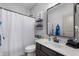 Bright bathroom featuring a shower with a white curtain and a dark wood vanity with a white sink at 1614 Waterleaf Dr, Westfield, IN 46074