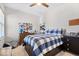 Bedroom featuring a plaid comforter, dark wood furnishings, and a playful display of decor at 1614 Waterleaf Dr, Westfield, IN 46074