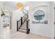 Bright foyer with staircase, light hardwood floors, and modern light fixture at 1614 Waterleaf Dr, Westfield, IN 46074