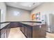 Modern kitchenette featuring sleek dark cabinetry, granite countertops, and stainless steel appliances at 1614 Waterleaf Dr, Westfield, IN 46074