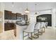 Modern kitchen island with breakfast bar seating, pendant lighting, stainless appliances and open dining area at 1614 Waterleaf Dr, Westfield, IN 46074