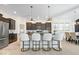 Modern kitchen with granite countertops, stainless steel appliances, and island seating at 1614 Waterleaf Dr, Westfield, IN 46074