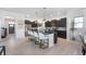 Modern kitchen with dark cabinets, granite countertops, stainless steel appliances and a breakfast bar at 1614 Waterleaf Dr, Westfield, IN 46074
