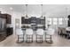 Modern kitchen boasts a large island with seating, stainless steel appliances, and dark wood cabinets at 1614 Waterleaf Dr, Westfield, IN 46074