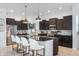 Modern kitchen with dark cabinets, granite countertops and stainless steel appliances at 1614 Waterleaf Dr, Westfield, IN 46074