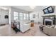 Bright living room with white sofa, fireplace, mantel and large windows at 1614 Waterleaf Dr, Westfield, IN 46074