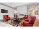 Comfortable lounge area with plush red armchairs and a contemporary fireplace at 1614 Waterleaf Dr, Westfield, IN 46074