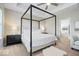 Serene main bedroom featuring tray ceilings, a stylish canopy bed, and a view into the ensuite bathroom at 1614 Waterleaf Dr, Westfield, IN 46074