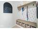 Well-organized mudroom with built-in storage and decorative wallpaper at 1614 Waterleaf Dr, Westfield, IN 46074