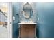 Chic powder room with unique blue wallpaper, decorative mirror, and modern vanity with storage at 1614 Waterleaf Dr, Westfield, IN 46074