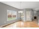 Bright dining room with hardwood floors, large windows overlooking the backyard and fireplace view at 16350 Quartz Dr, Noblesville, IN 46060