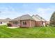 Brick house exterior with a patio, screened in porch and a well maintained backyard at 16350 Quartz Dr, Noblesville, IN 46060