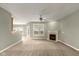 Bright living room with a fireplace, neutral carpet, a ceiling fan, and large windows for natural light at 16350 Quartz Dr, Noblesville, IN 46060