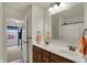 Modern bathroom boasting double sinks, a framed mirror, and a rod & curtain-enclosed shower at 16758 Bingham Dr, Westfield, IN 46074