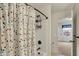 Bright bathroom featuring a shower with a colorful curtain and bronze fixtures at 16758 Bingham Dr, Westfield, IN 46074