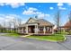 Community clubhouse featuring a brick facade, white columns, and manicured landscaping at 16758 Bingham Dr, Westfield, IN 46074