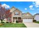 Charming two-story home featuring brick accents, red shutters, and a well-manicured lawn at 16758 Bingham Dr, Westfield, IN 46074