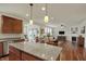 Open kitchen with pendant lighting overlooking the dining and living areas at 16758 Bingham Dr, Westfield, IN 46074